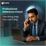 A professional man in a suit is conducting a reference check over the phone while working on a laptop, promoting OnGrid's professional reference check service.